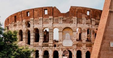 Colosseum (Coliseum) in Rome, Italy. Roman Colosseum is one of the main travel attractions of Rome. Panoramic view of Rome with Coliseum. Historical architecture of central Rome.