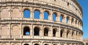 Facade of the Colosseum in central Rome on a sunny summer day