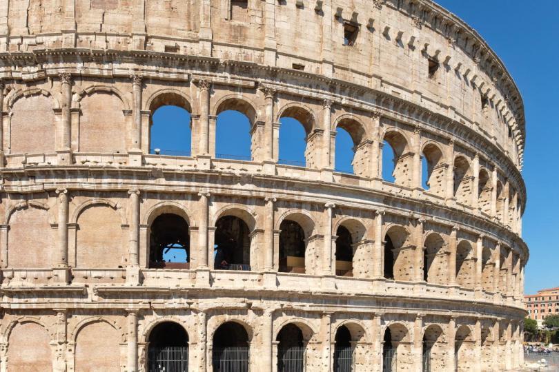 Facade of the Colosseum in central Rome on a sunny summer day