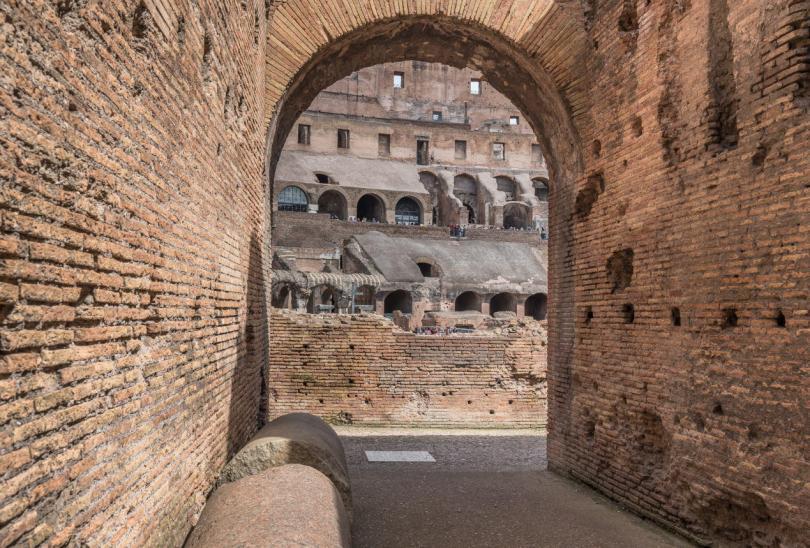 The Colosseum, Rome, Italy_March 29, 2018 Arched entrance (80 in total) into the largest oval amphitheater built by the Flavian dynasty, an iconic majestic symbol of Imperial Rome