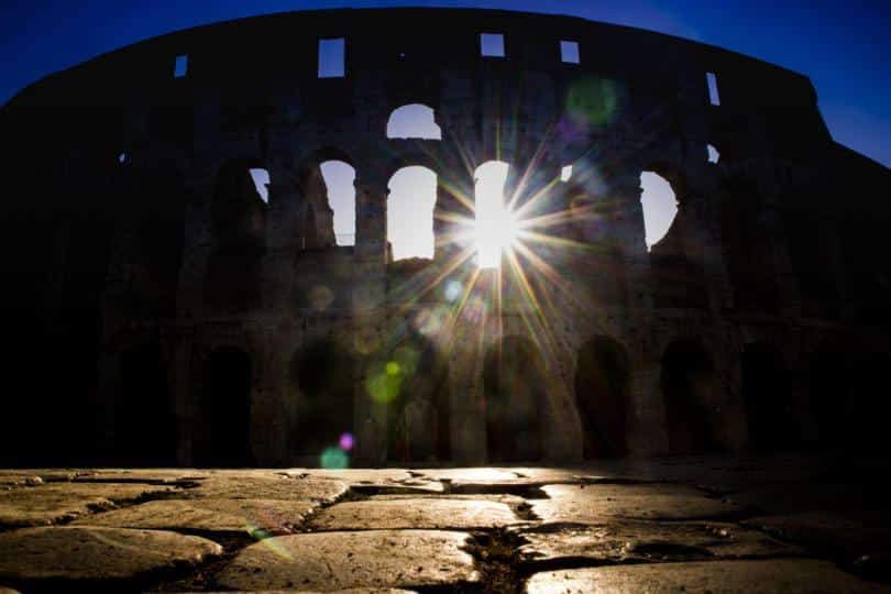 The monument of the Colosseum in Rome Italy taken back in against light to the dawn