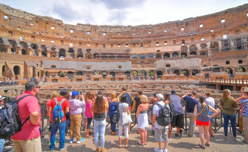 Tourists visit the Roman vestiges inside the Colosseum, major touristic attraction in Rome, Italy-4
