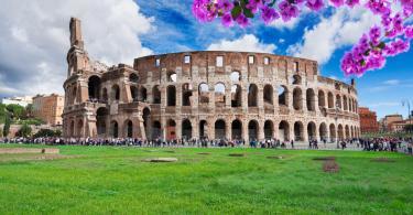 ruins of antique Colosseum building at spring day with flowers in Rome Italy