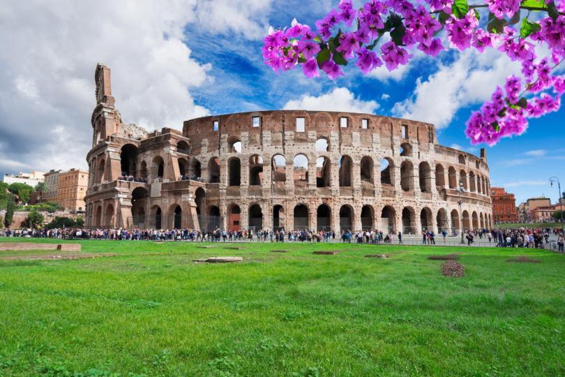 ruins of antique Colosseum building at spring day with flowers in Rome Italy