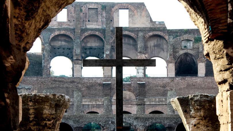A crucifix stands at the Roman Coliseum.