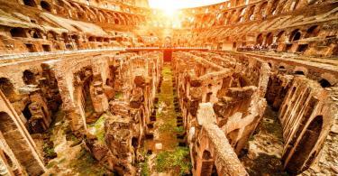 Inside the Colosseum or Coliseum in summer, Italy. Colosseum is the main travel attraction of Roma. Ruins of the Colosseum arena. Panoramic view of Colosseum in the sunlight.