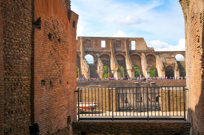 Tourists visit the Roman vestiges inside the Colosseum, major touristic attraction in Rome, Italy-3