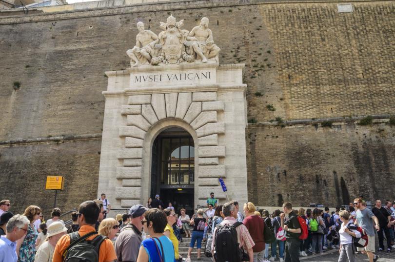 Long lines of tourists and believers outside the entrance of Vatican City, walls of Vatican, Rome