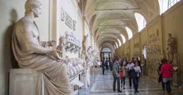 Roman marble sculptures from Museums of Vatican. Exhibition hall with lots to people