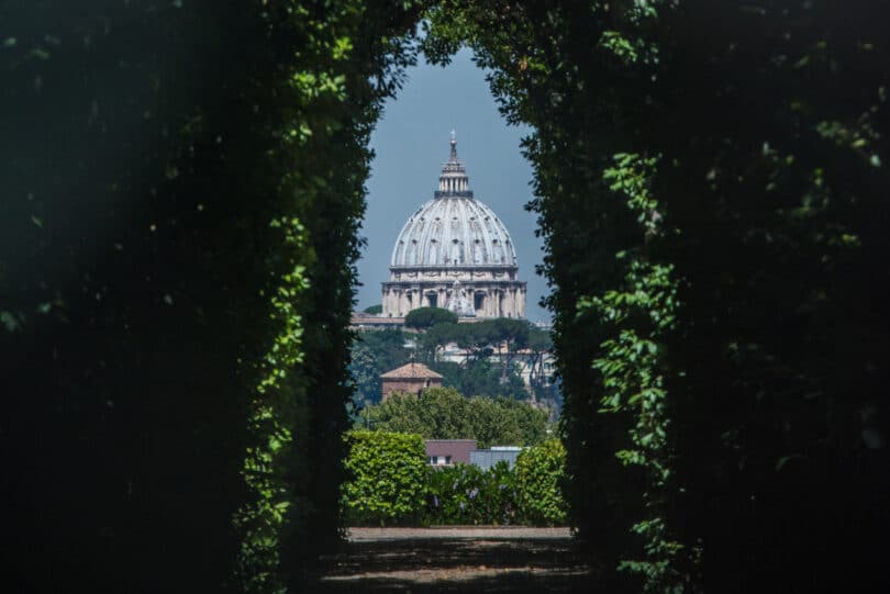 The dome of Saint Peters Basilica seen through the famous keyhole at the the gate of the Priory of the Knights of Malta on Aventino Hill. Rome, Italy, Southern Europe