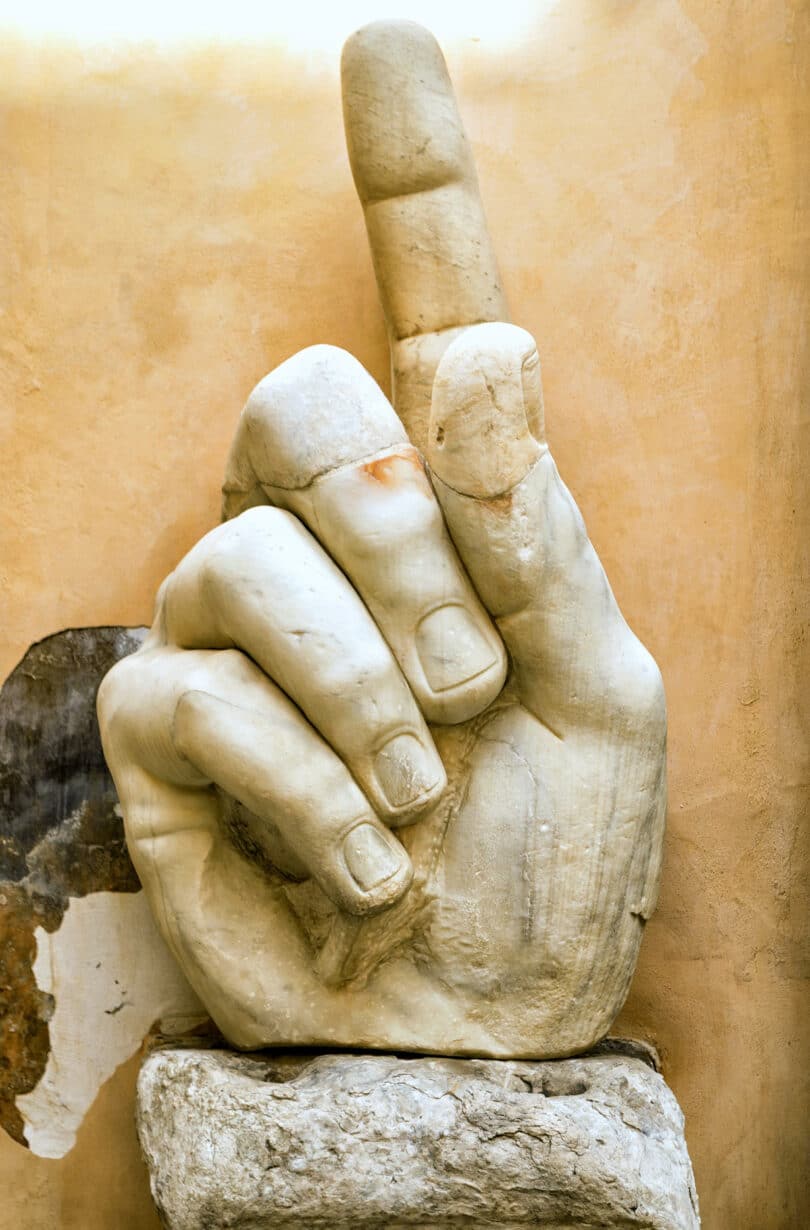 Fragment of a giant statue of Constantine the Great at the Capitoline Hill. Stone hand with raised index finger of Constantine's colossus in Capitoline museum outdoor.