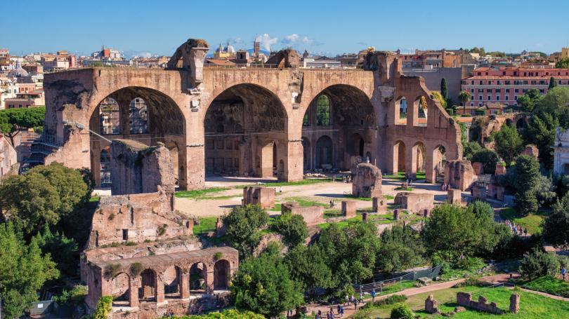Red stone Basilica of Maxentius with arcs in Rome, Italy