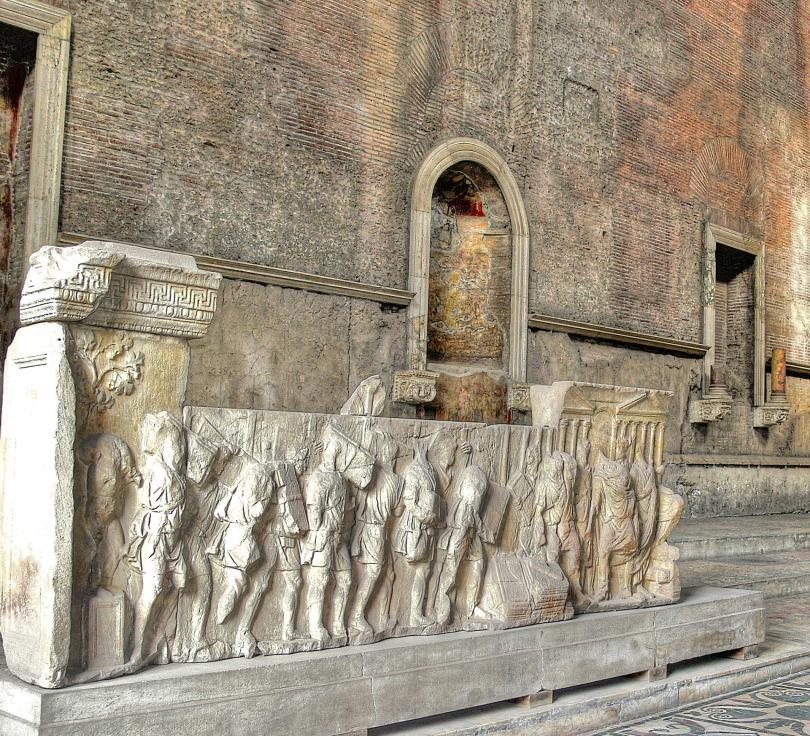 Marble carvings, perhaps the parapets of the tiered seating, with scenes of the reign of Trajan (98-117 AD) destruction of the debt wlls and (right) institution of the public food supply.