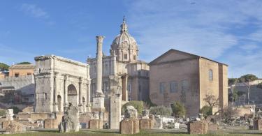 Roman ruins with Curia and Triumphal Arch of Septimius Severus on Roman forum in Rome, Italy