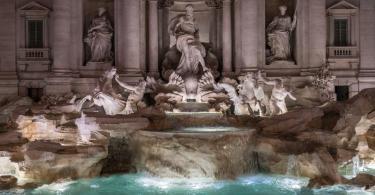 The sculptures of the Ocean and the two tritons, with the winged horses in the central part in Trevi Fountain by night.