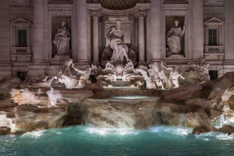 The sculptures of the Ocean and the two tritons, with the winged horses in the central part in Trevi Fountain by night.