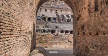 Colosseum & Roman Forum and Palatine Package- Arched entrance (80 in total) into the largest oval amphitheater built by the Flavian dynasty, an iconic majestic symbol of Imperial Rome