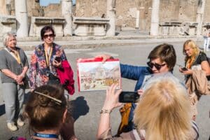 A tourist group listening to their archaeologist guide in the streets of Pompeii