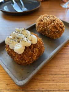 Crispy Roman supplì rice croquette filled with mozzarella and tomato sauce.