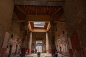 Detailed Roman-era frescoes decorating the walls of the House of the Vettii in the ancient city of Pompeii