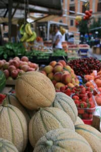 Fresh melons displayed at Mercato di San Cosimato in Trastevere, Rome